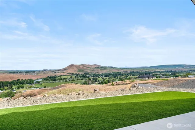 a view of a house with a yard and a garden
