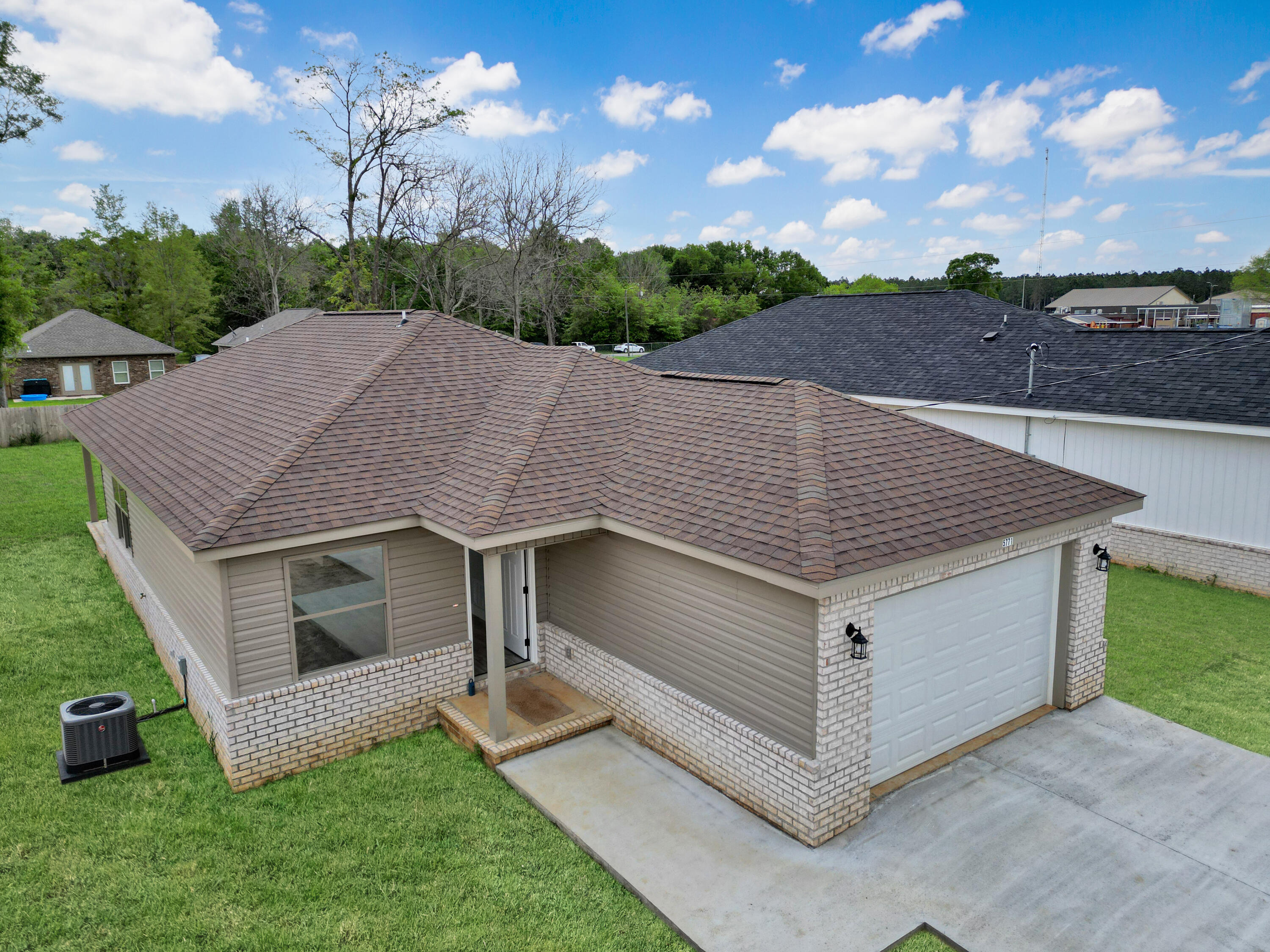 5771 Monroe Street Baker, FL 32531 - Photo 1 of 23 a aerial view of a house with a yard and potted plants