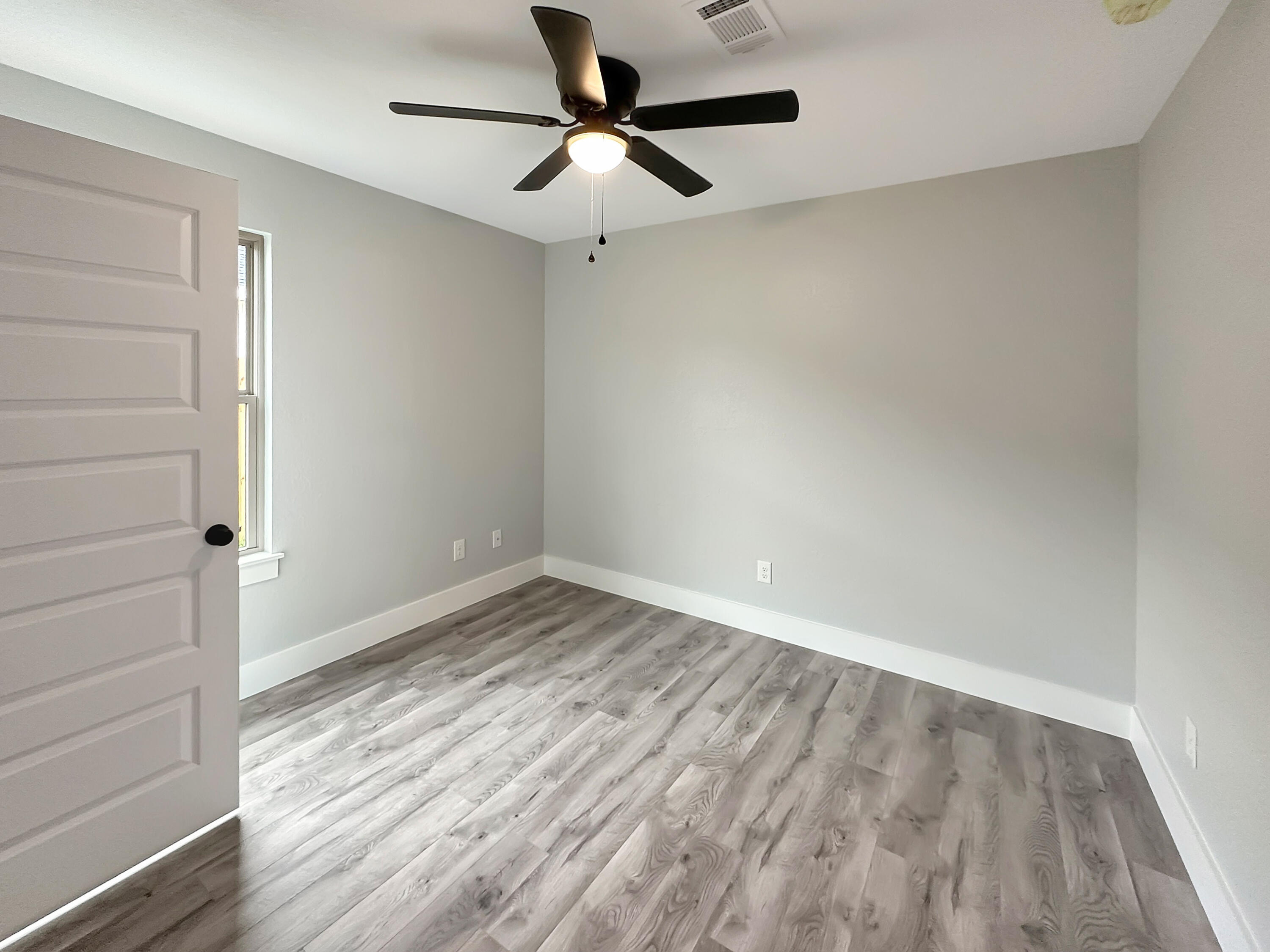 5771 Monroe Street Baker, FL 32531 - Photo 11 of 23 a view of empty room with wooden floor