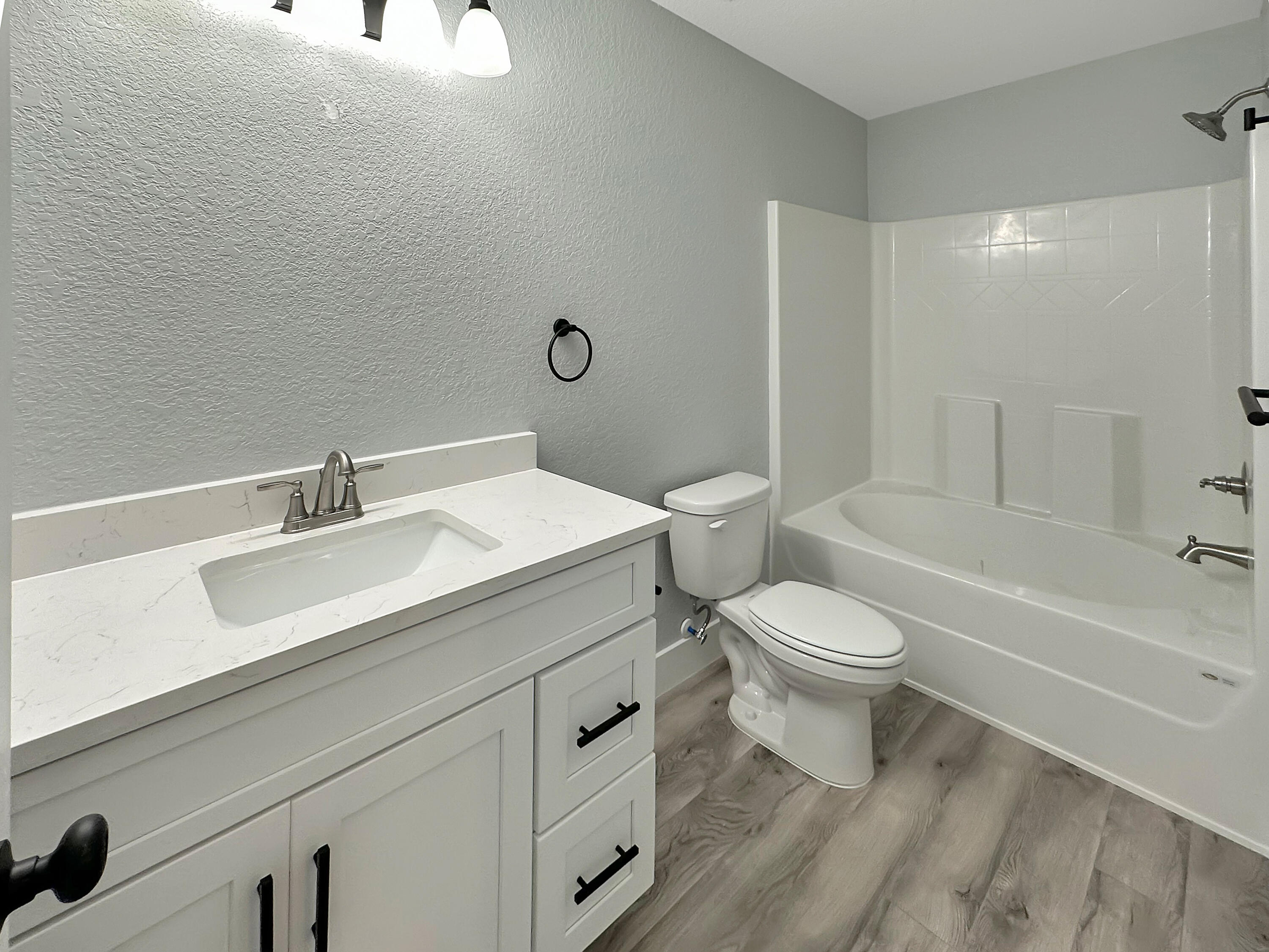 5771 Monroe Street Baker, FL 32531 - Photo 16 of 23 a white toilet sitting next to a bathroom sink