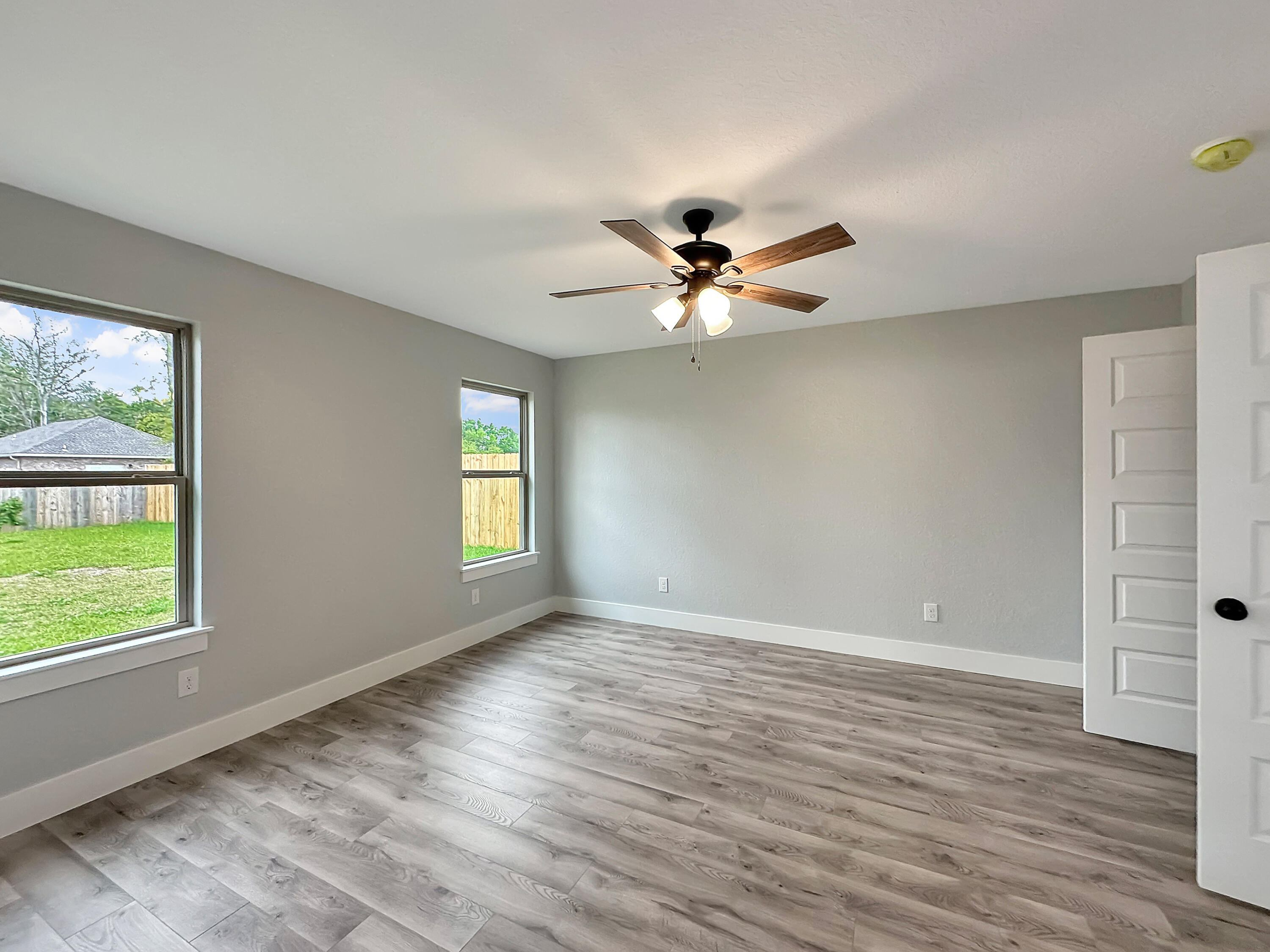 5771 Monroe Street Baker, FL 32531 - Photo 17 of 23 a view of an empty room with a window and wooden floor