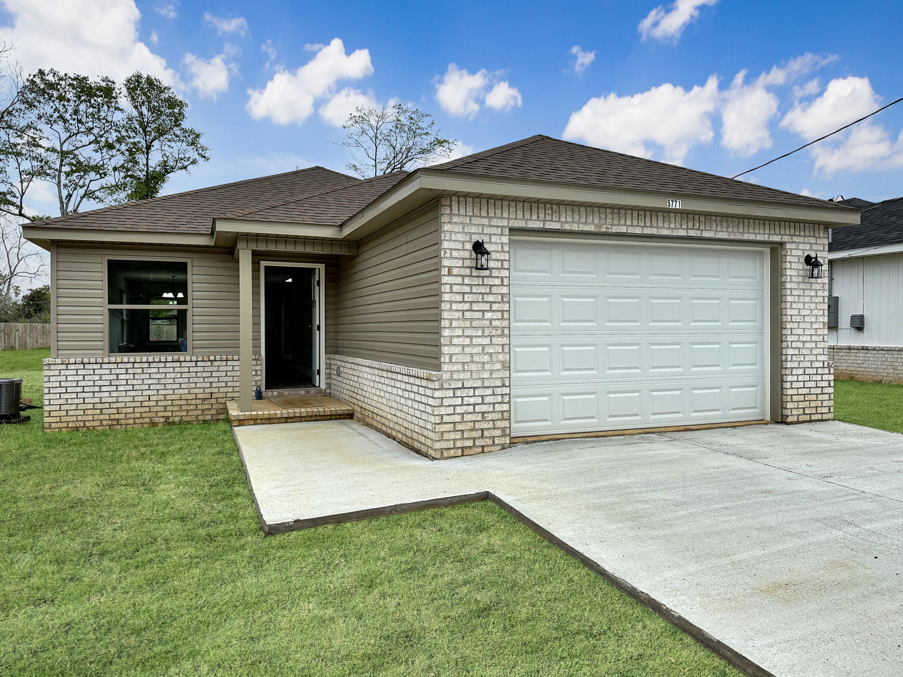 5771 Monroe Street Baker, FL 32531 - Photo 20 of 23 a front view of a house with a yard