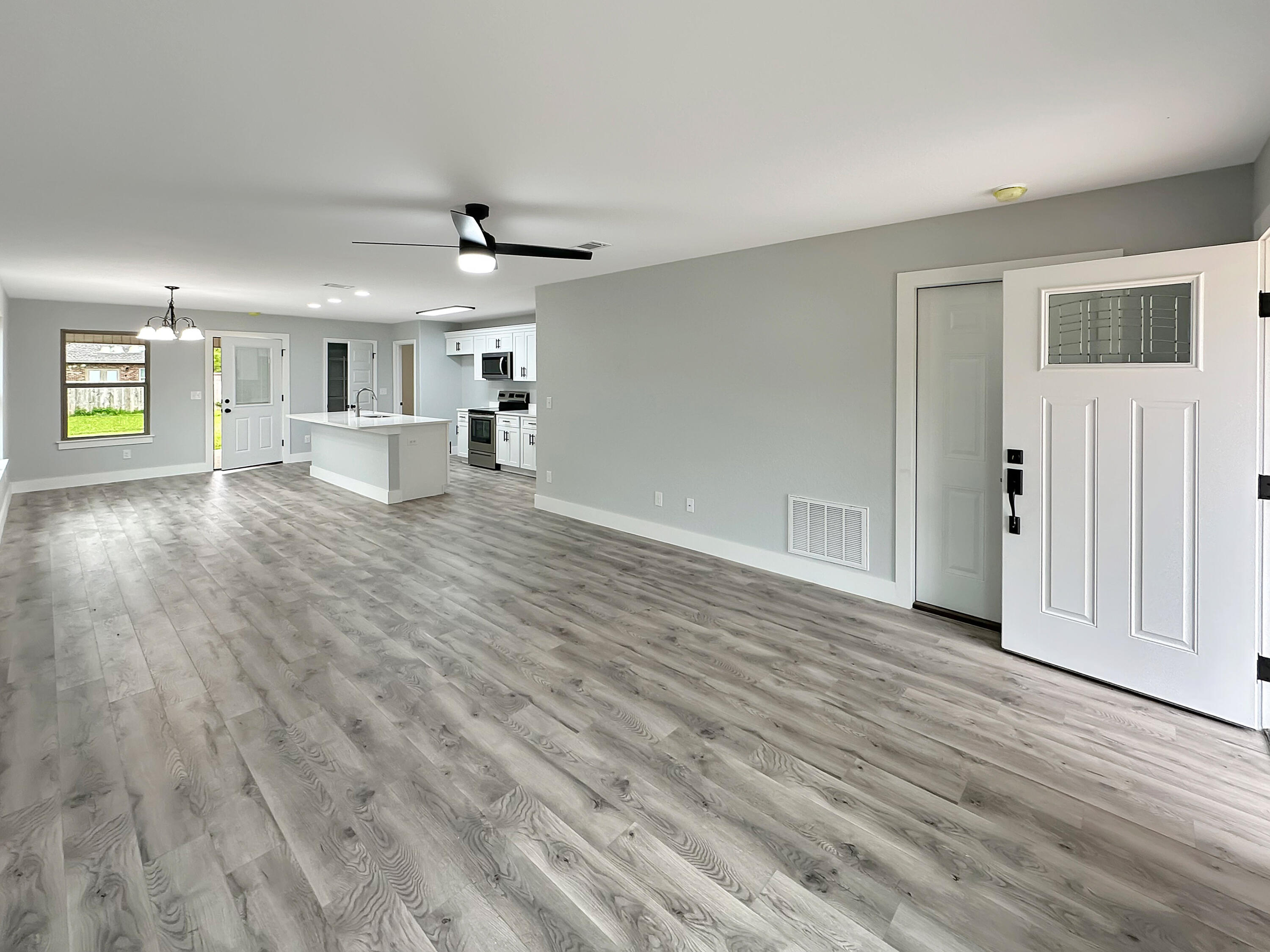 5771 Monroe Street Baker, FL 32531 - Photo 2 of 23 wooden floor in an empty room with a window