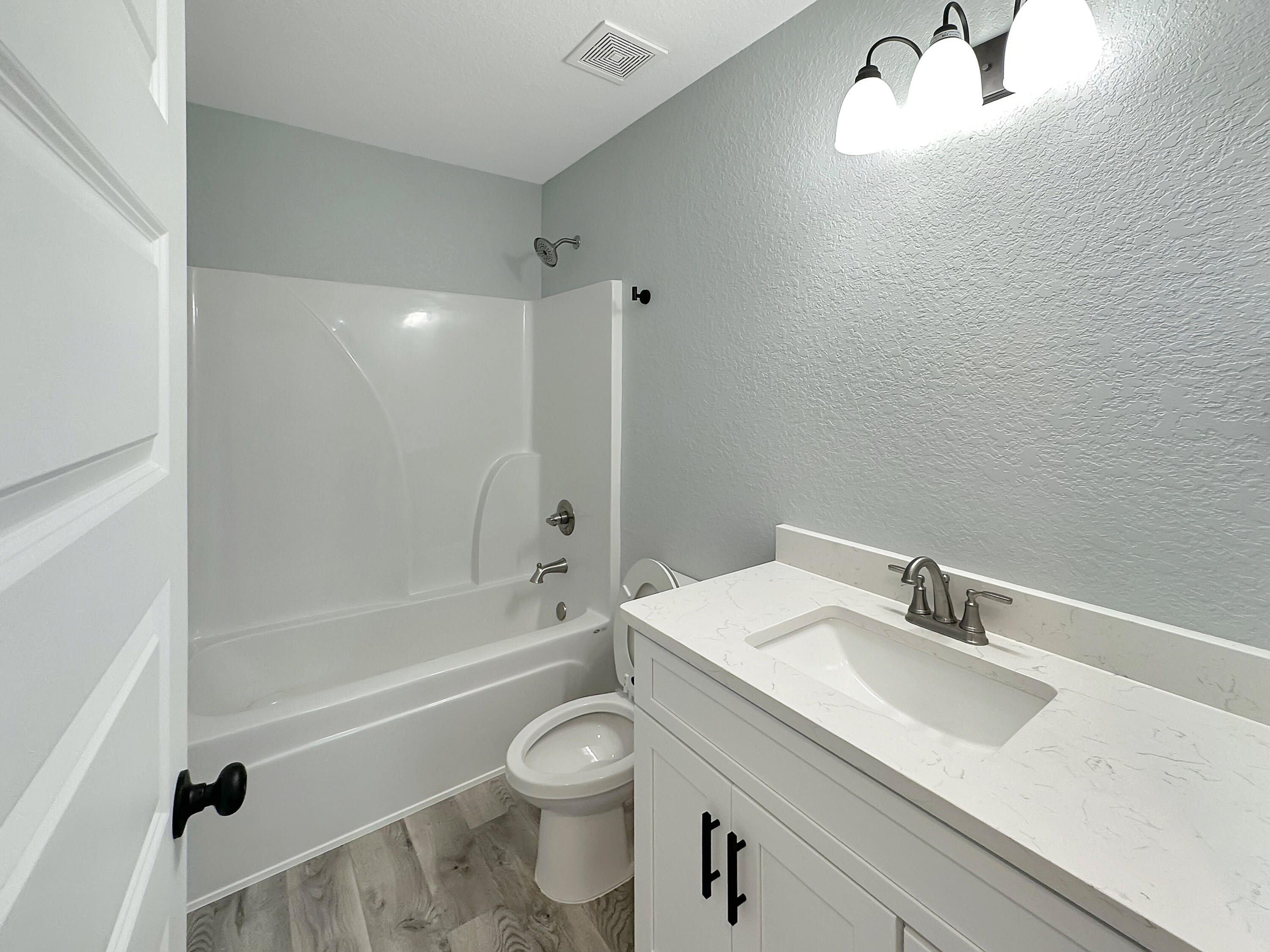 5771 Monroe Street Baker, FL 32531 - Photo 10 of 23 a bathroom with a sink a toilet and a bathtub