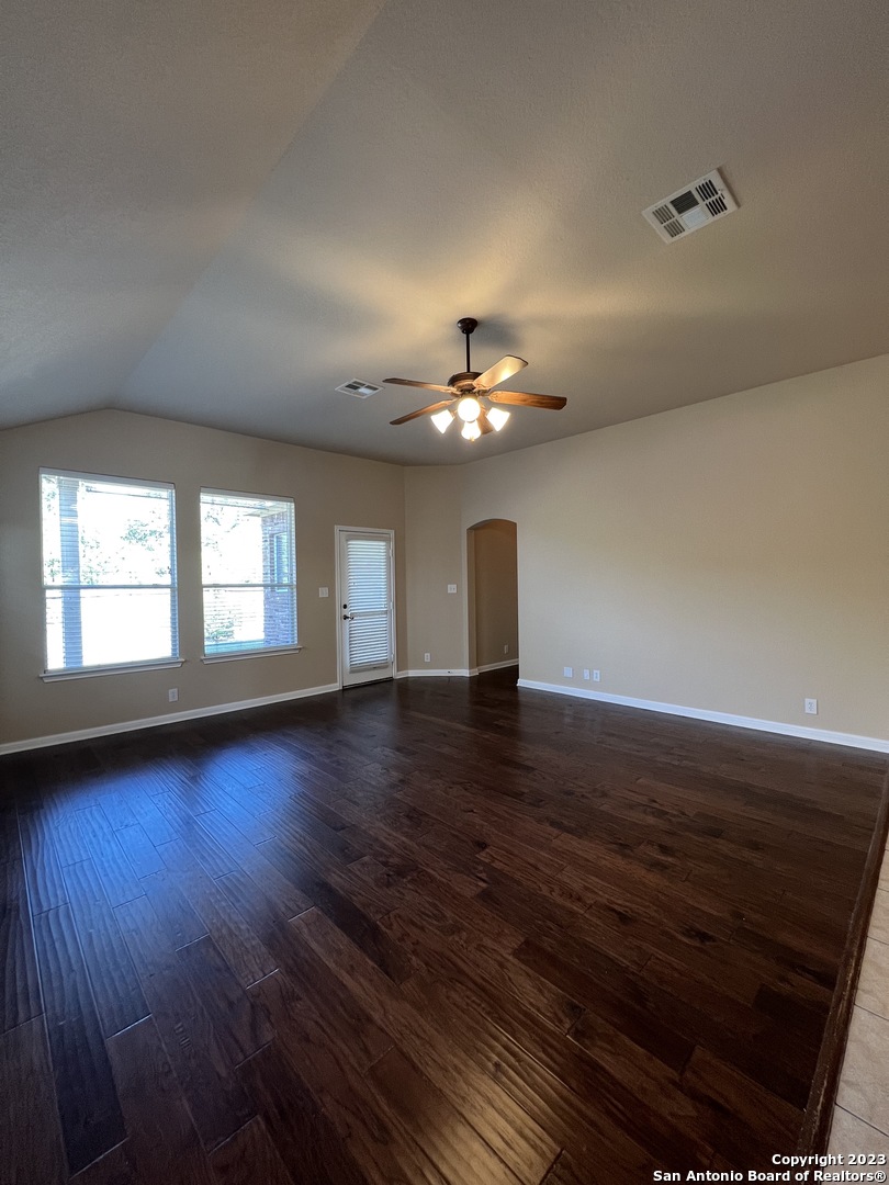 24431 Flint Creek San Antonio, TX 78255 - Photo 15 of 45 a view of an empty room with wooden floor and a window