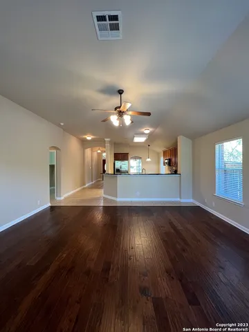 wooden floor in an empty room with a window