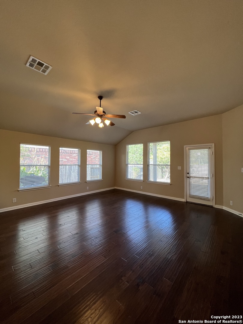 24431 Flint Creek San Antonio, TX 78255 - Photo 20 of 45 a view of an empty room with wooden floor and a window