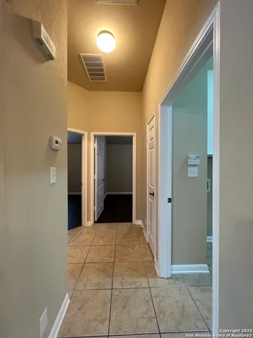 a view of a hallway with wooden shelves