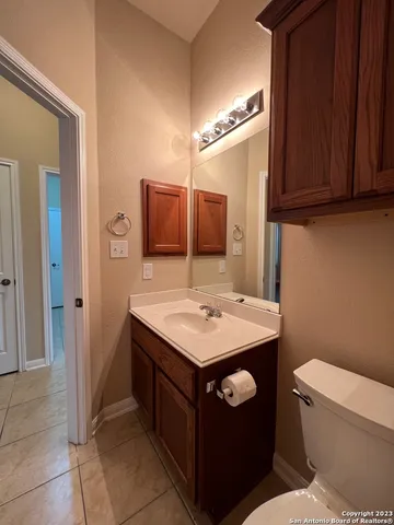 a bathroom with a sink a toilet and mirror