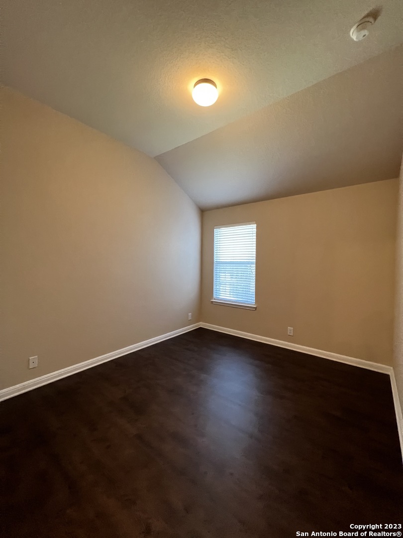 24431 Flint Creek San Antonio, TX 78255 - Photo 27 of 45 an empty room with wooden floor and windows