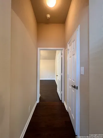 a view of a hallway with a wooden floor