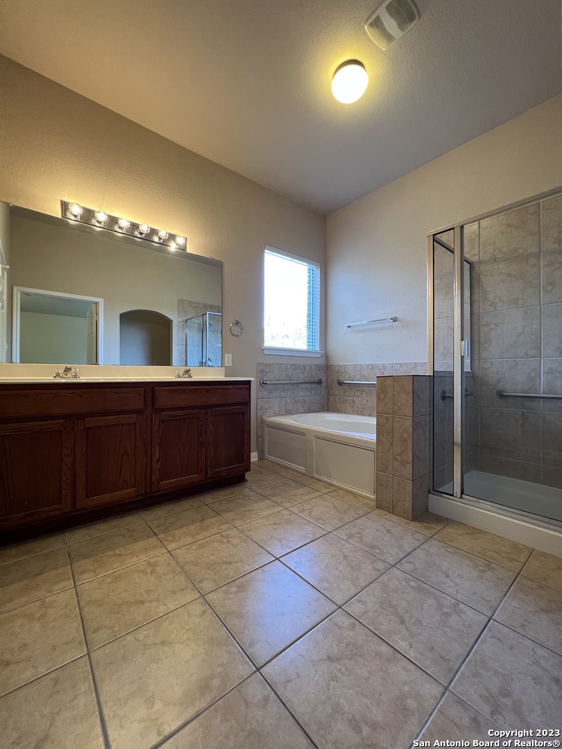 24431 Flint Creek San Antonio, TX 78255 - Photo 39 of 45 a large bathroom with a large tub shower and sink