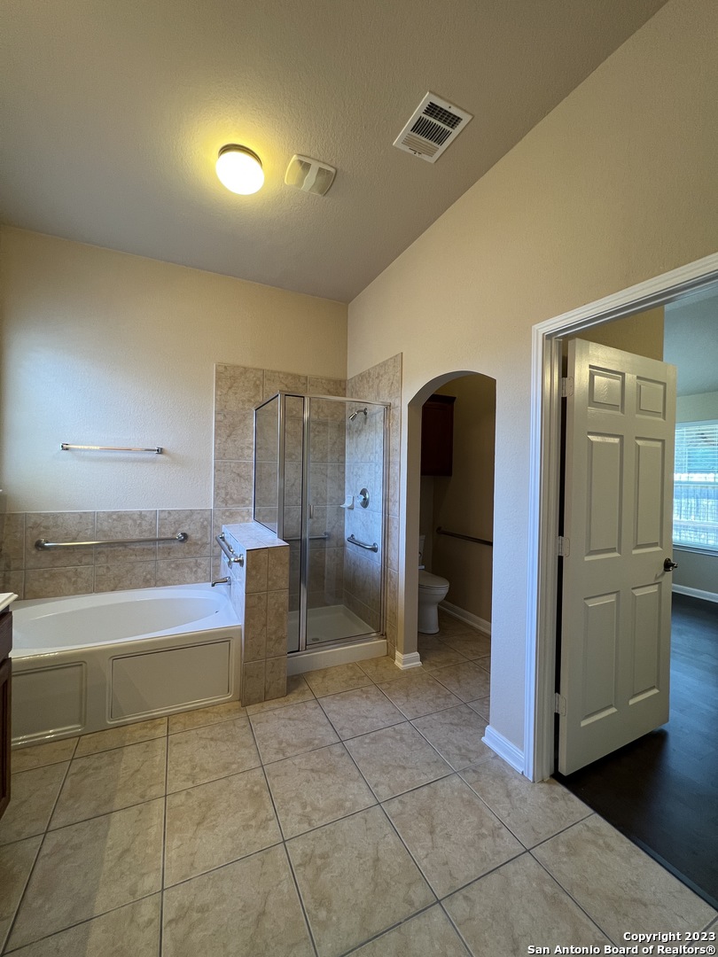 24431 Flint Creek San Antonio, TX 78255 - Photo 41 of 45 a bathroom with a tub shower and mirror