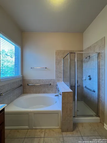 a bathroom with a bathtub and a shower