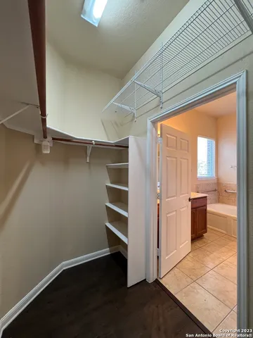 a view of an empty room with a fireplace and a window