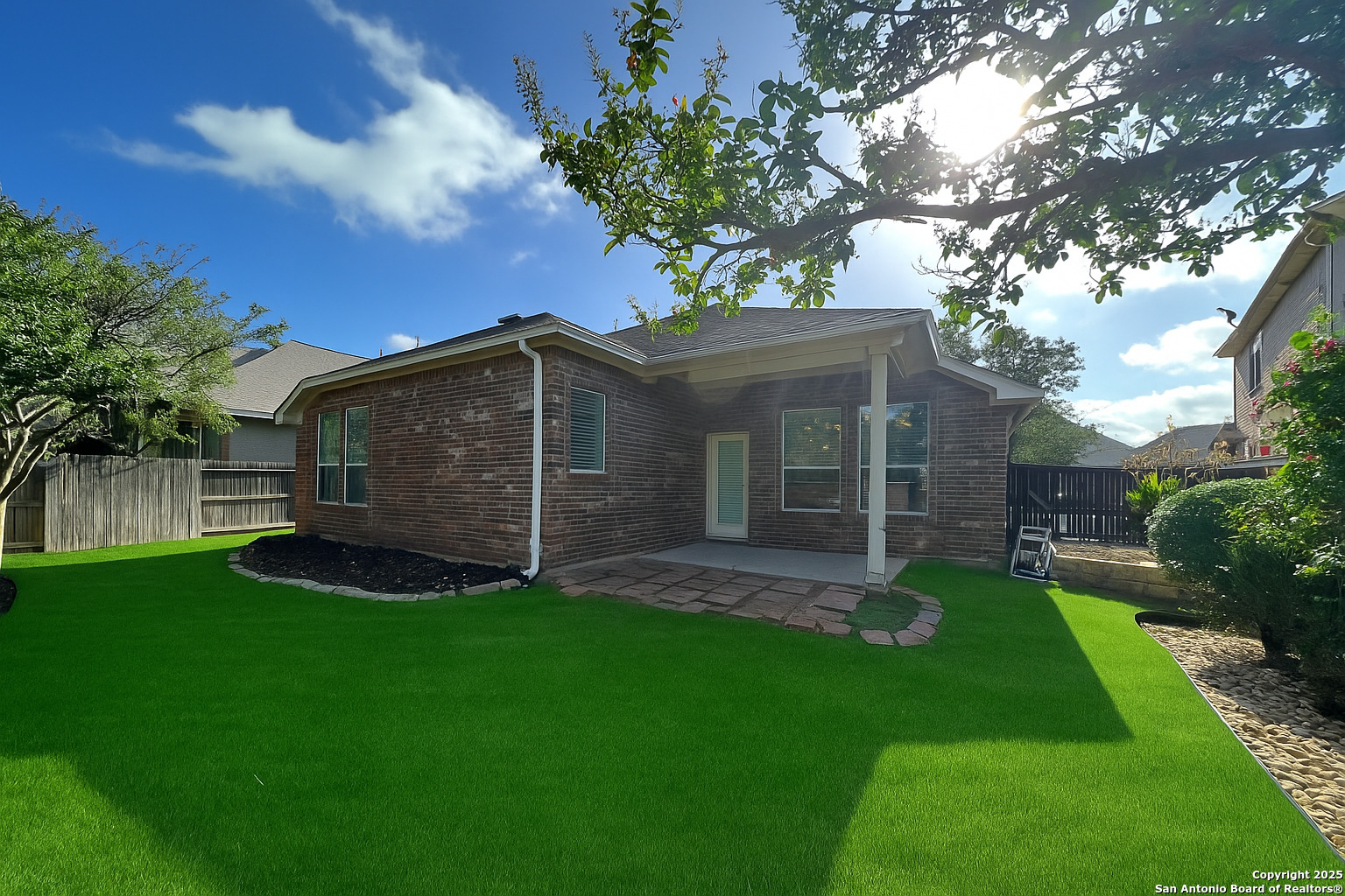 24431 Flint Creek San Antonio, TX 78255 - Photo 45 of 45 a view of a backyard with table and chairs and a large tree