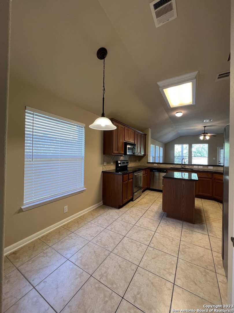24431 Flint Creek San Antonio, TX 78255 - Photo 6 of 45 a large kitchen with stainless steel appliances kitchen island granite countertop a sink counter space and a view of kitchen