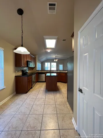 a kitchen with stainless steel appliances granite countertop a refrigerator and a sink