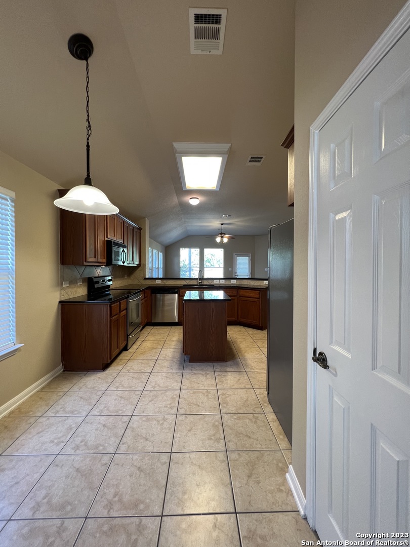 24431 Flint Creek San Antonio, TX 78255 - Photo 8 of 45 a kitchen with stainless steel appliances granite countertop a refrigerator and a sink