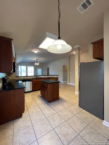 a kitchen with stainless steel appliances granite countertop a refrigerator and a sink