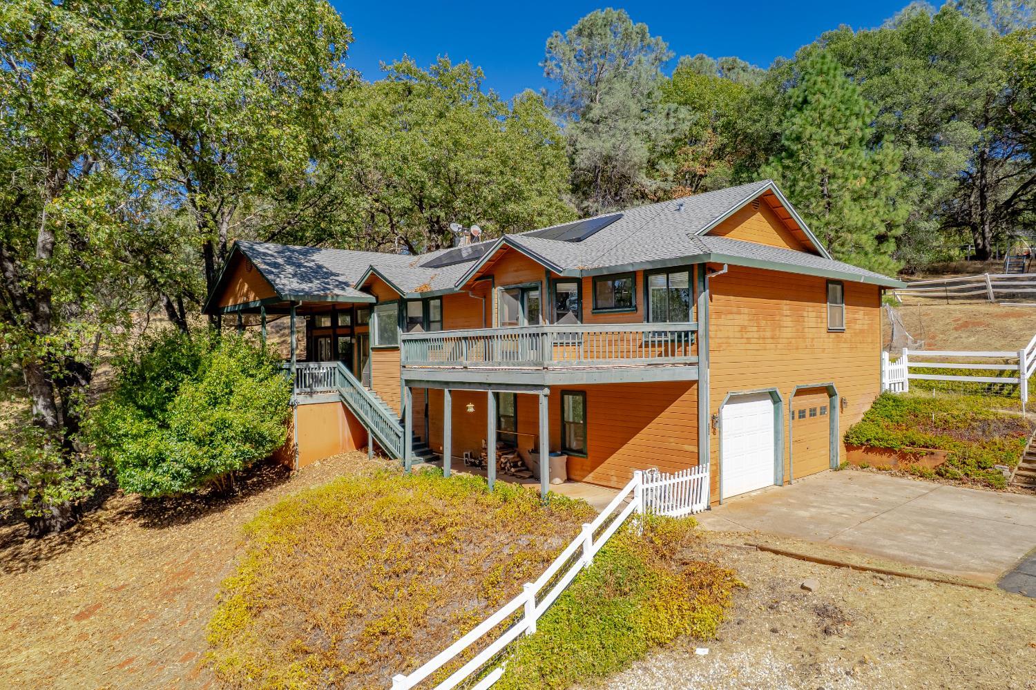 a front view of a house with a yard and trees