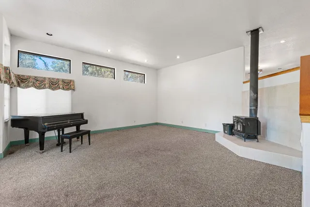 a large kitchen with stainless steel appliances granite countertop a stove a sink dishwasher and a refrigerator