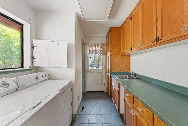 a bathroom with a granite countertop toilet sink and mirror