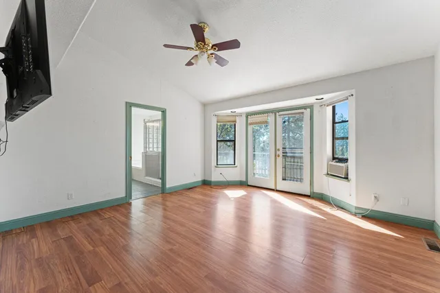 a spacious bathroom with a tub sink and mirror