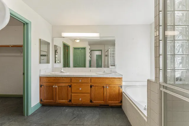 a view of a balcony with wooden floor and iron fence