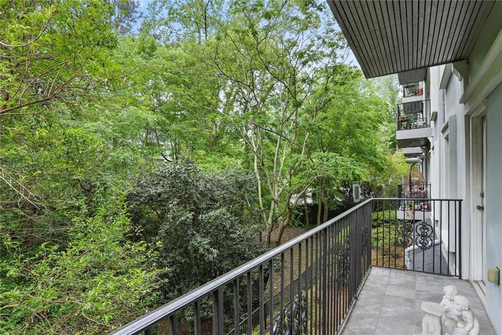 3203 Lenox Road Northeast, Unit 6 Atlanta, GA 30324 - Photo 19 of 27 a balcony with trees in front of it