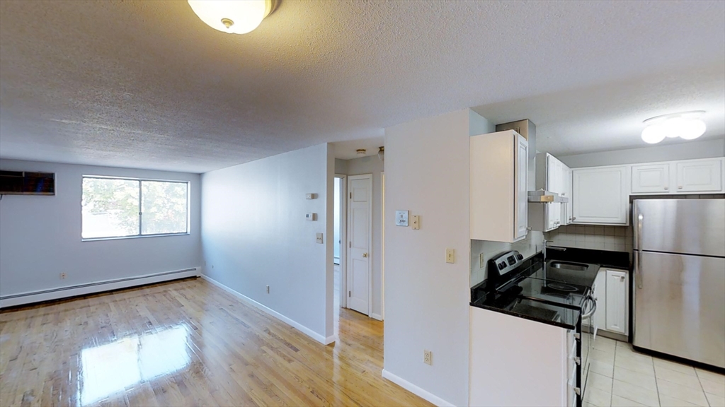 a kitchen with a refrigerator and a stove top oven