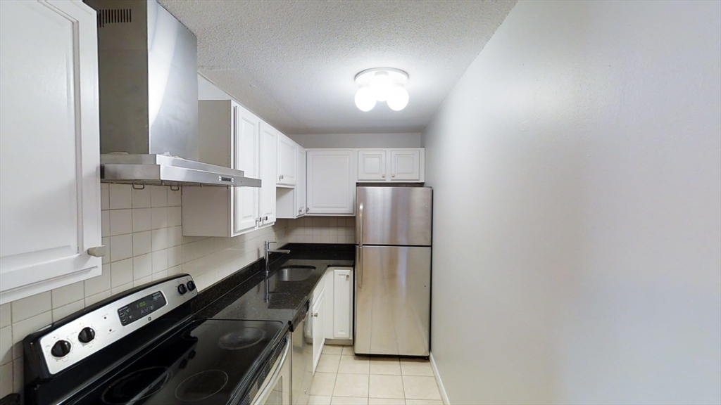 14 Murdock Street, Unit 17 Somerville, MA 02145 - Photo 2 of 12 a kitchen with a refrigerator and a stove