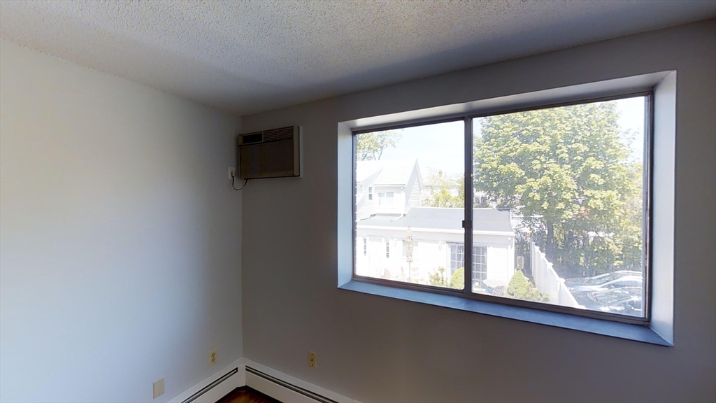 14 Murdock Street, Unit 17 Somerville, MA 02145 - Photo 3 of 12 a view of a big room with wooden floor and windows