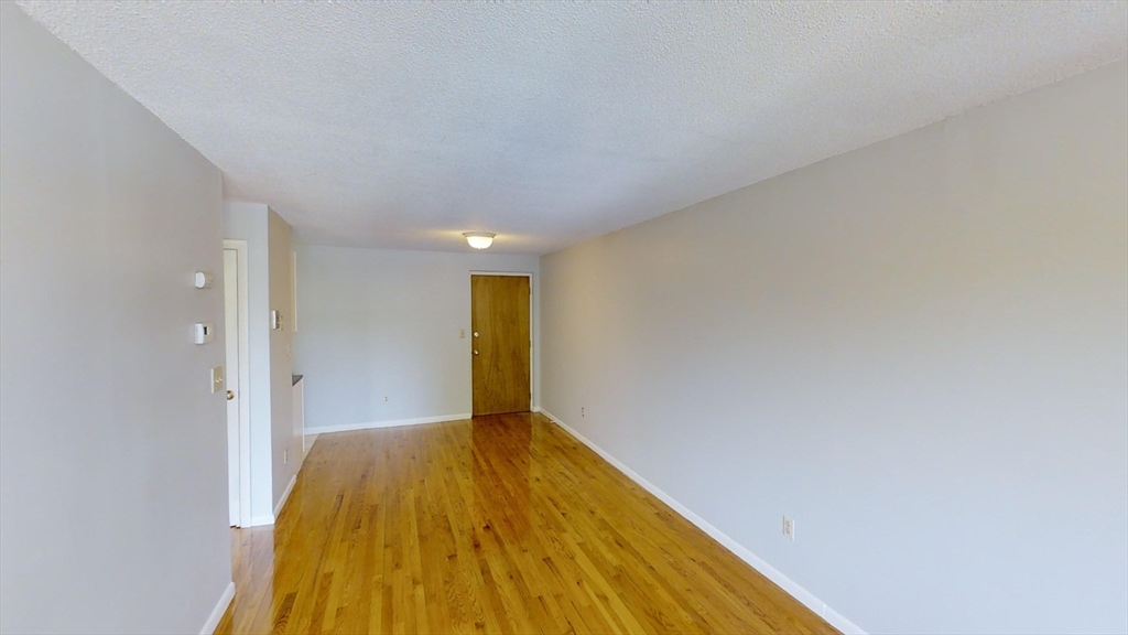 14 Murdock Street, Unit 17 Somerville, MA 02145 - Photo 4 of 12 a view of a big room with wooden floor