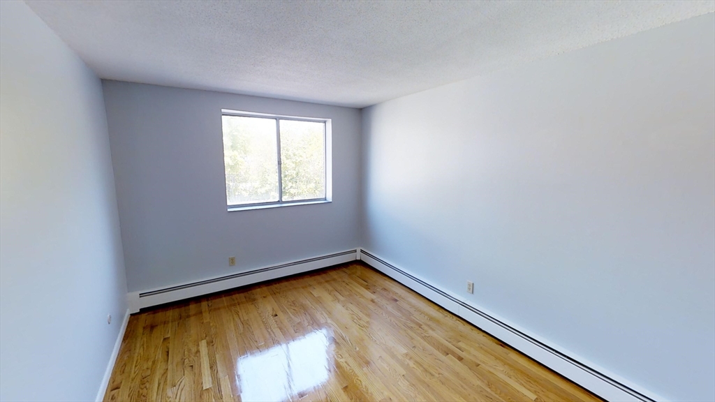 14 Murdock Street, Unit 17 Somerville, MA 02145 - Photo 6 of 12 an empty room with a window
