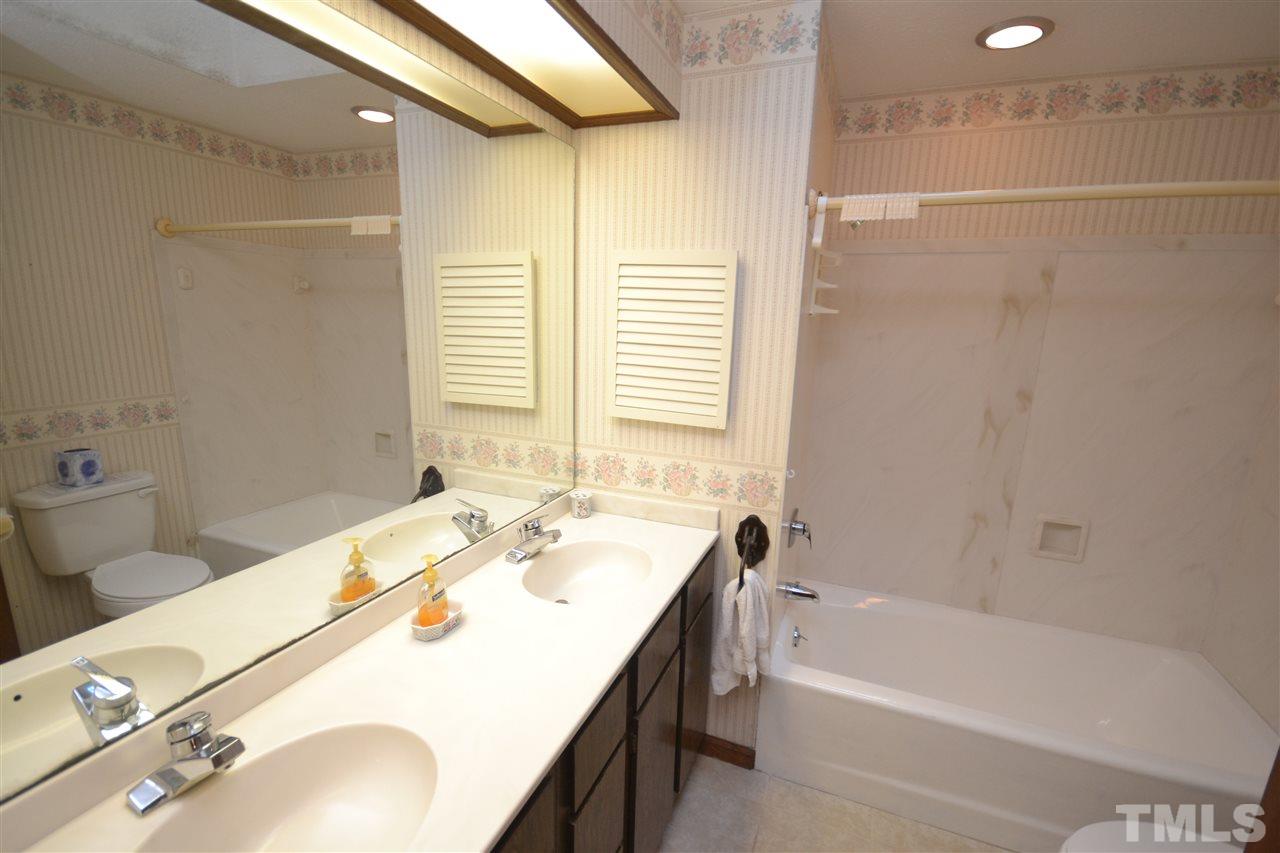 2400 Windsor Trail Raleigh, NC 27615 - Photo 13 of 19 a bathroom with a tub sink and mirror