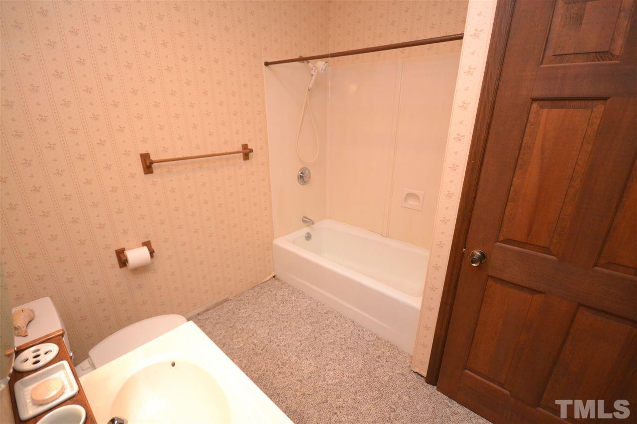 2400 Windsor Trail Raleigh, NC 27615 - Photo 18 of 19 a bathroom with a granite countertop sink toilet and shower