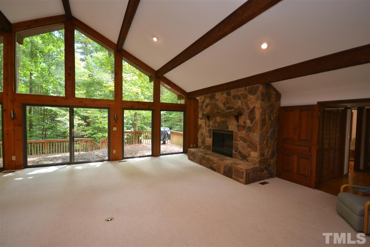 2400 Windsor Trail Raleigh, NC 27615 - Photo 5 of 19 a view of an empty room with a fireplace and a large window