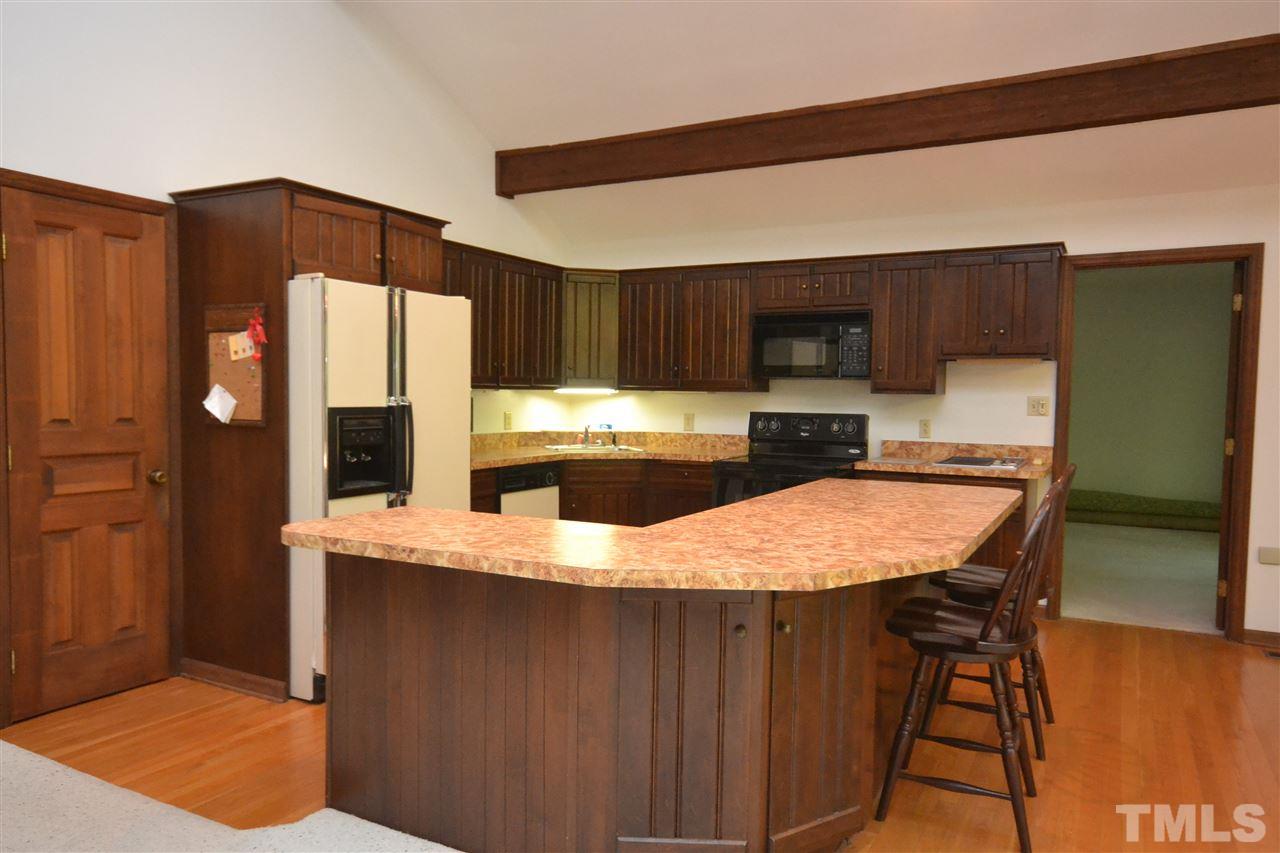 2400 Windsor Trail Raleigh, NC 27615 - Photo 7 of 19 a kitchen with stainless steel appliances kitchen island granite countertop a refrigerator a stove top oven a sink and dishwasher