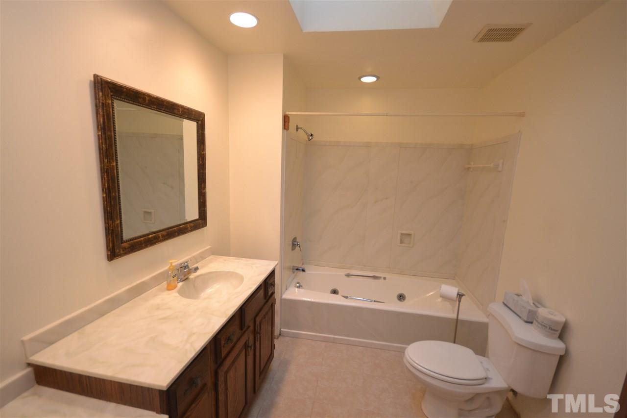 2400 Windsor Trail Raleigh, NC 27615 - Photo 10 of 19 a bathroom with a granite countertop sink mirror vanity and toilet