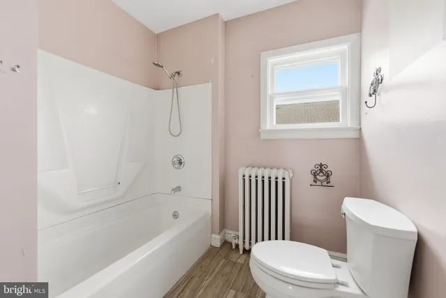 a bathroom with a toilet and a bathtub