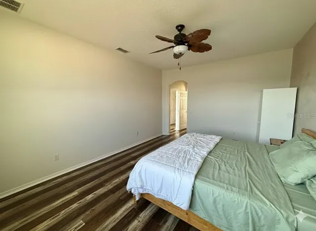 a bedroom with a bed and a chandelier