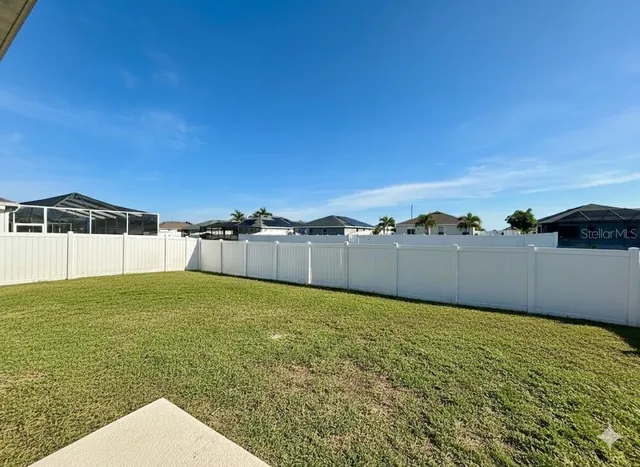 a view of a big yard with a house