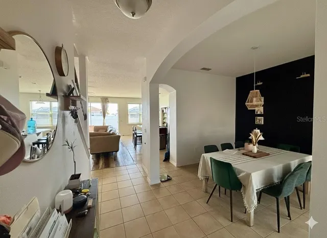 a living room with furniture a rug and white walls