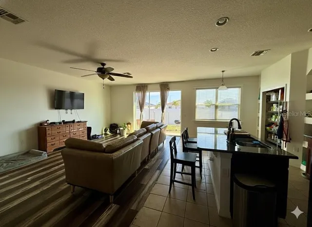 a living room with furniture a large window and a flat screen tv