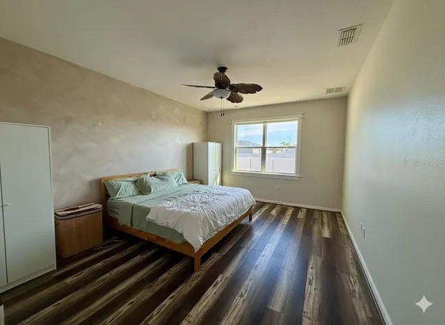 a bedroom with bed and window