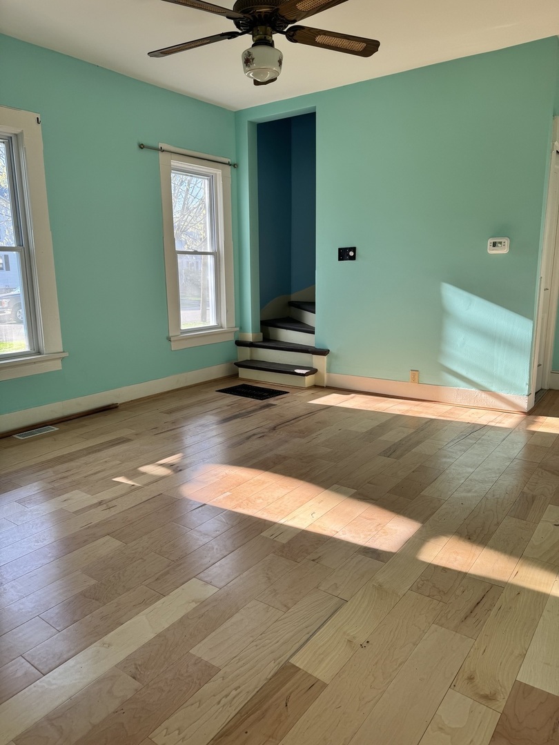 410 3rd Street Mendota, IL 61342 - Photo 3 of 18 a view of a livingroom with wooden floor and a window