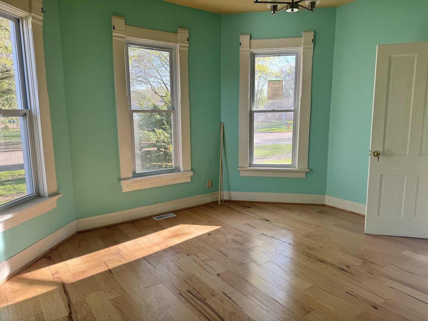 410 3rd Street Mendota, IL 61342 - Photo 4 of 18 an empty room with wooden floor and windows