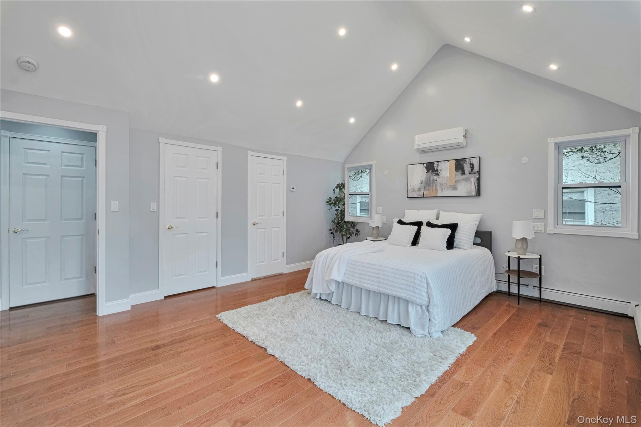 193 Nelson Road Scarsdale, NY 10583 - Photo 17 of 37 a spacious bedroom with a bed and a painting on the wall