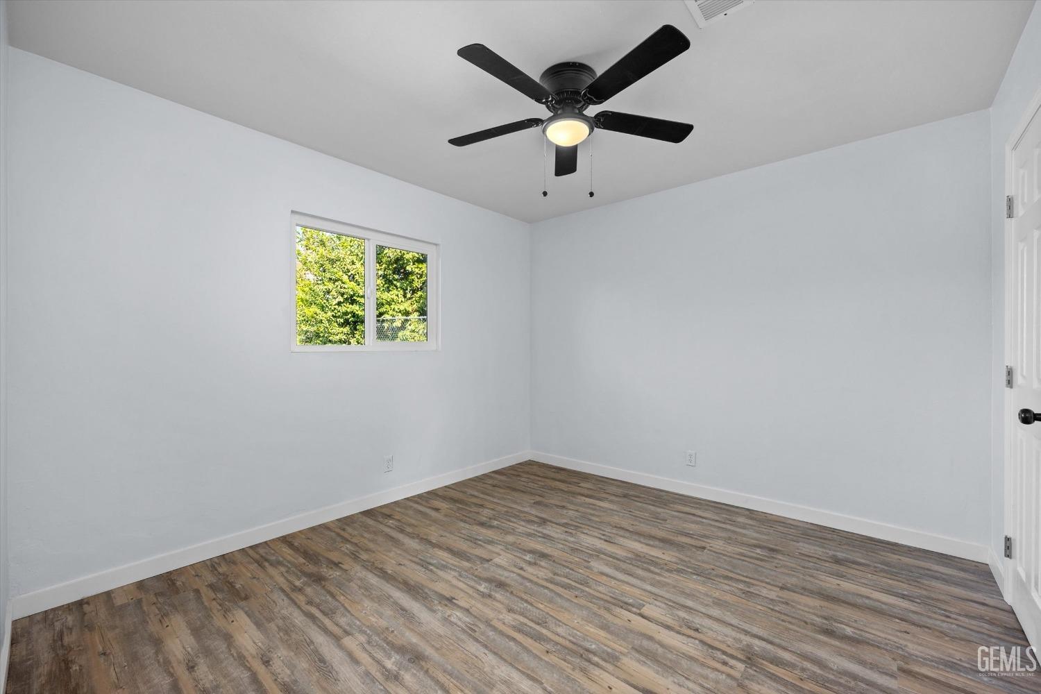 Undisclosed Address Bakersfield, CA 93306 - Photo 14 of 29 an empty room with a window and a ceiling fan